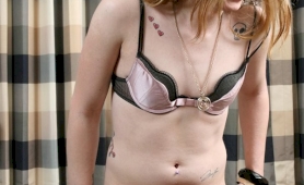 Tatooed american shemale teasing out of her clothes