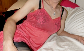 Sexy and slender crossdresser wearing pink negligee