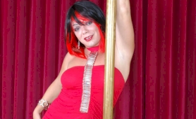Tgirl in a red dress stripping