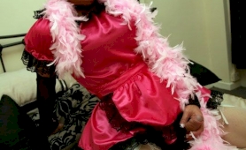 Tranny dressed up in pink frilly dress showing her cock